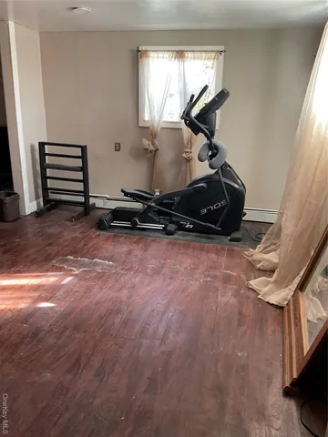 a room with wooden floor and window