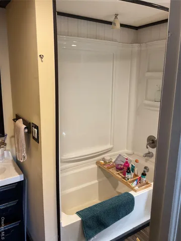 a bathroom with a tub and shower