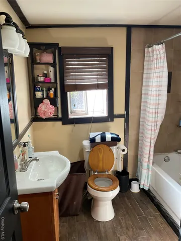 a white toilet sitting next to a bathroom sink