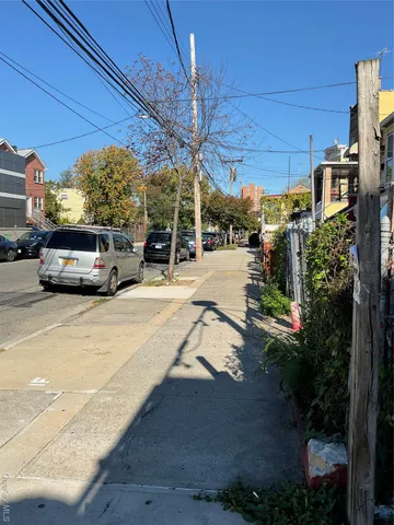 a view of a cars parked on the side of a street