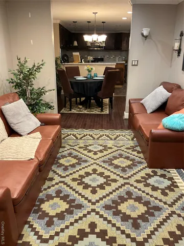 a large bedroom with a bed and a chandelier