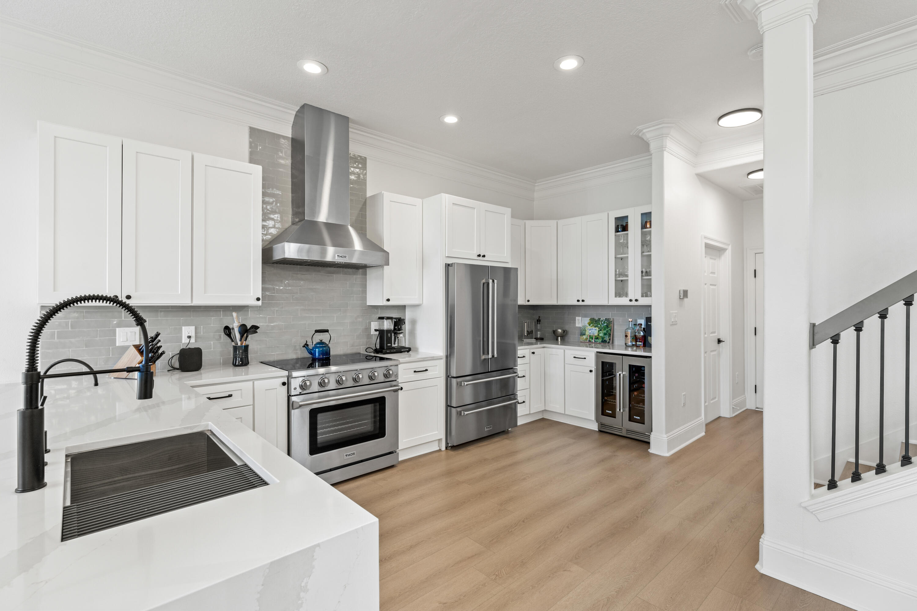 4591 Sailmaker Lane Destin, FL 32541 - Photo 11 of 41 a kitchen with white cabinets and stainless steel appliances