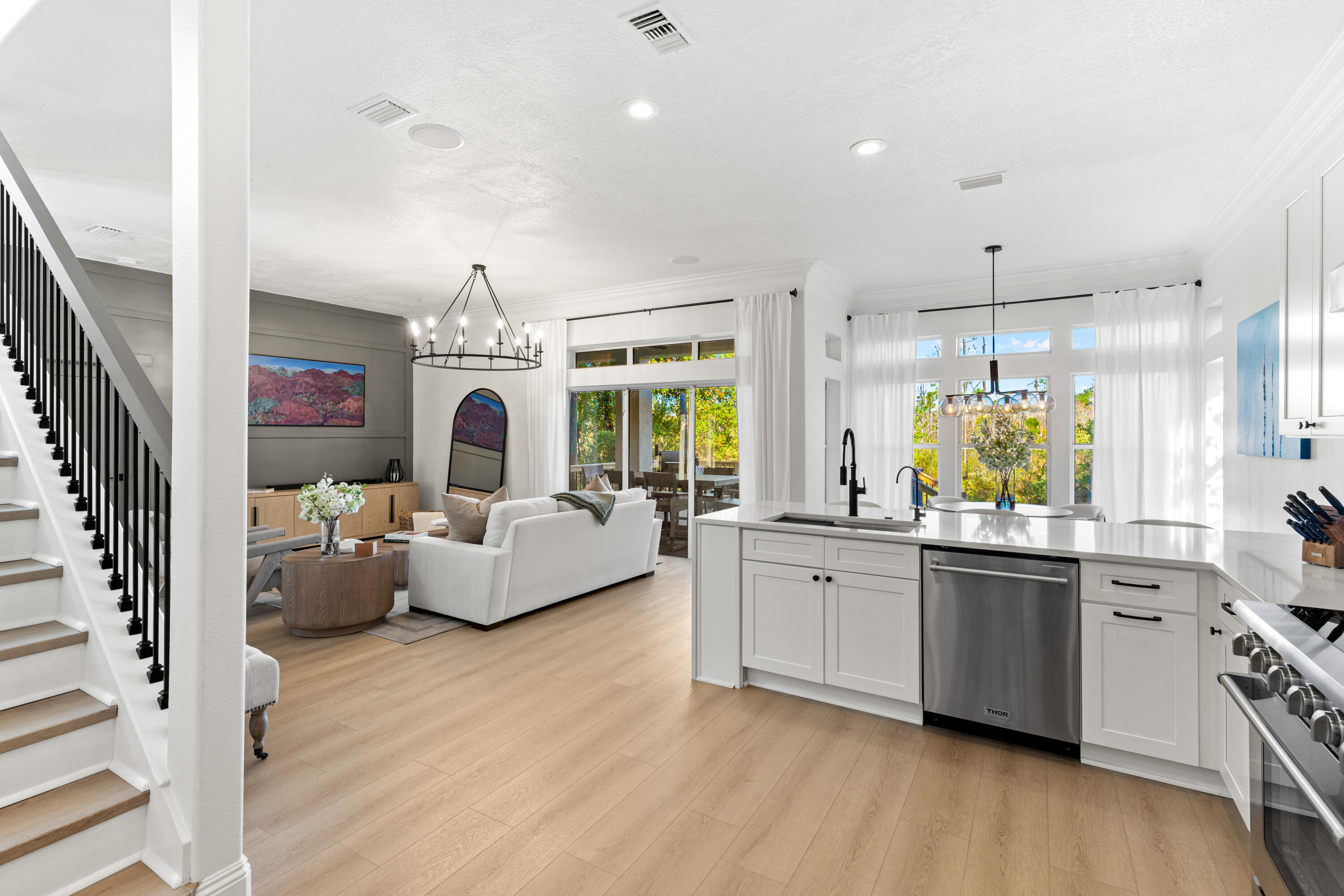 4591 Sailmaker Lane Destin, FL 32541 - Photo 12 of 41 a living room with stainless steel appliances furniture a chandelier and wooden floor