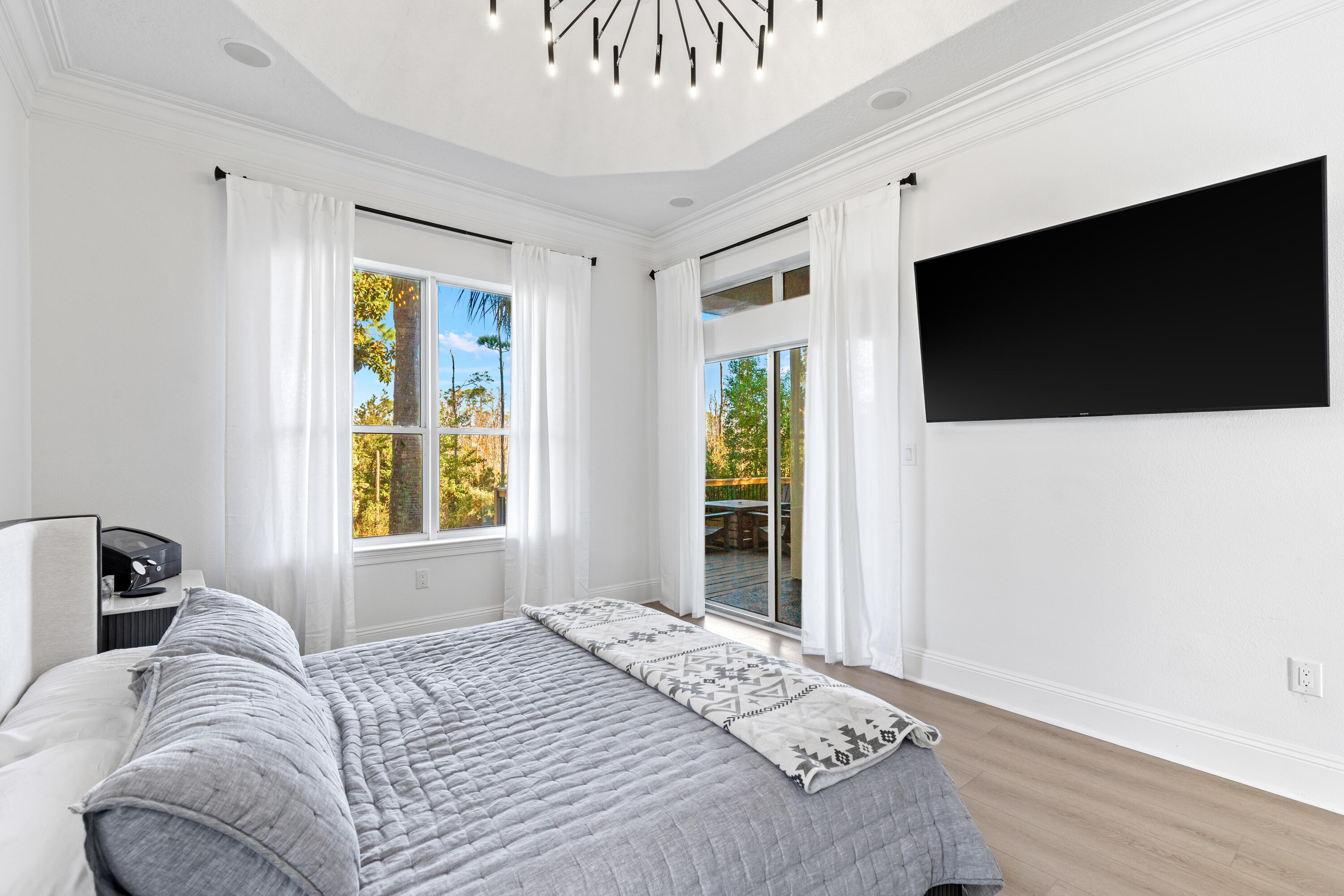 4591 Sailmaker Lane Destin, FL 32541 - Photo 17 of 41 a bedroom with a bed and a flat tv screen on the dresser