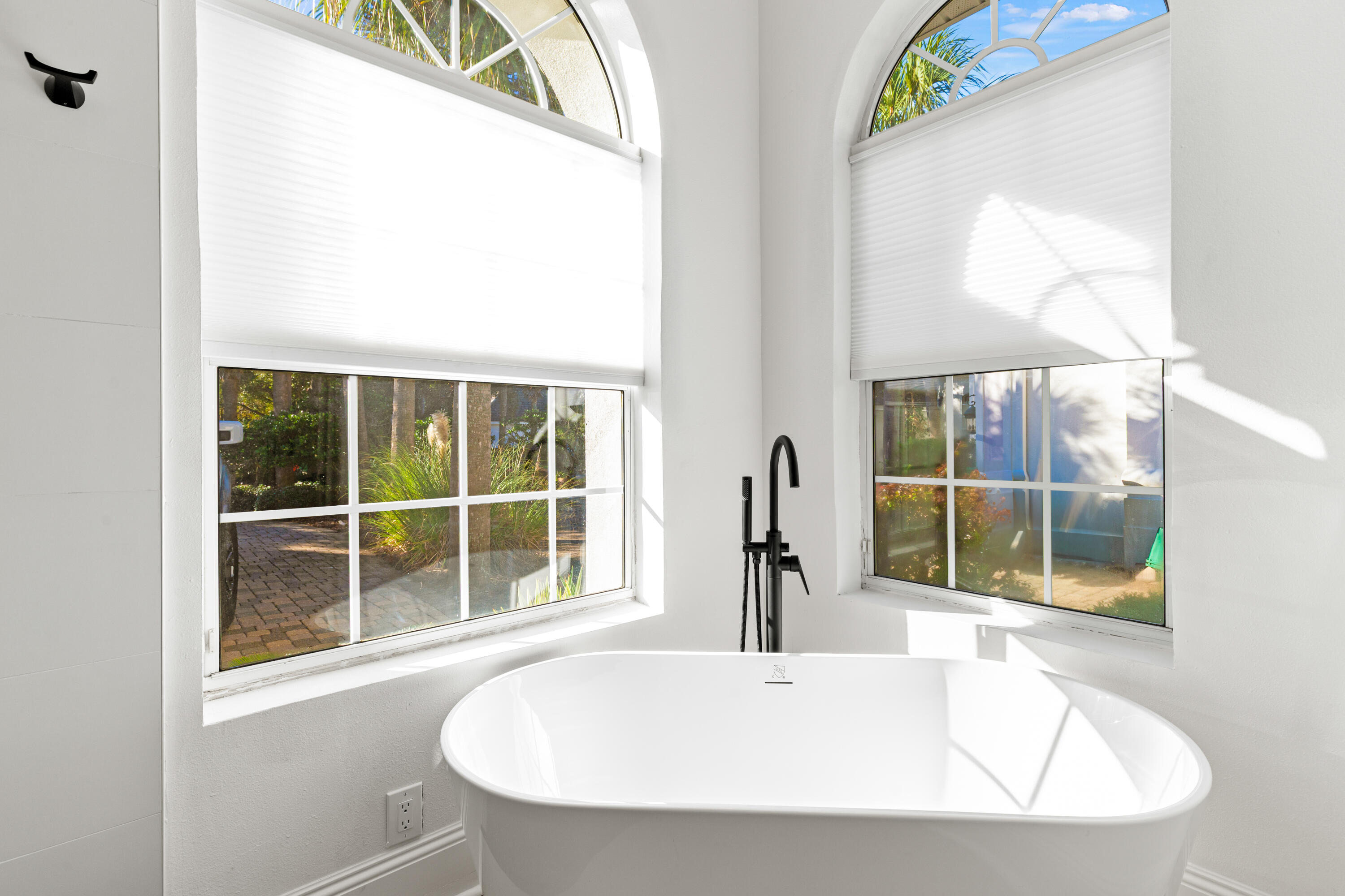 4591 Sailmaker Lane Destin, FL 32541 - Photo 19 of 41 a white bath tub sitting in a bathroom next to a window