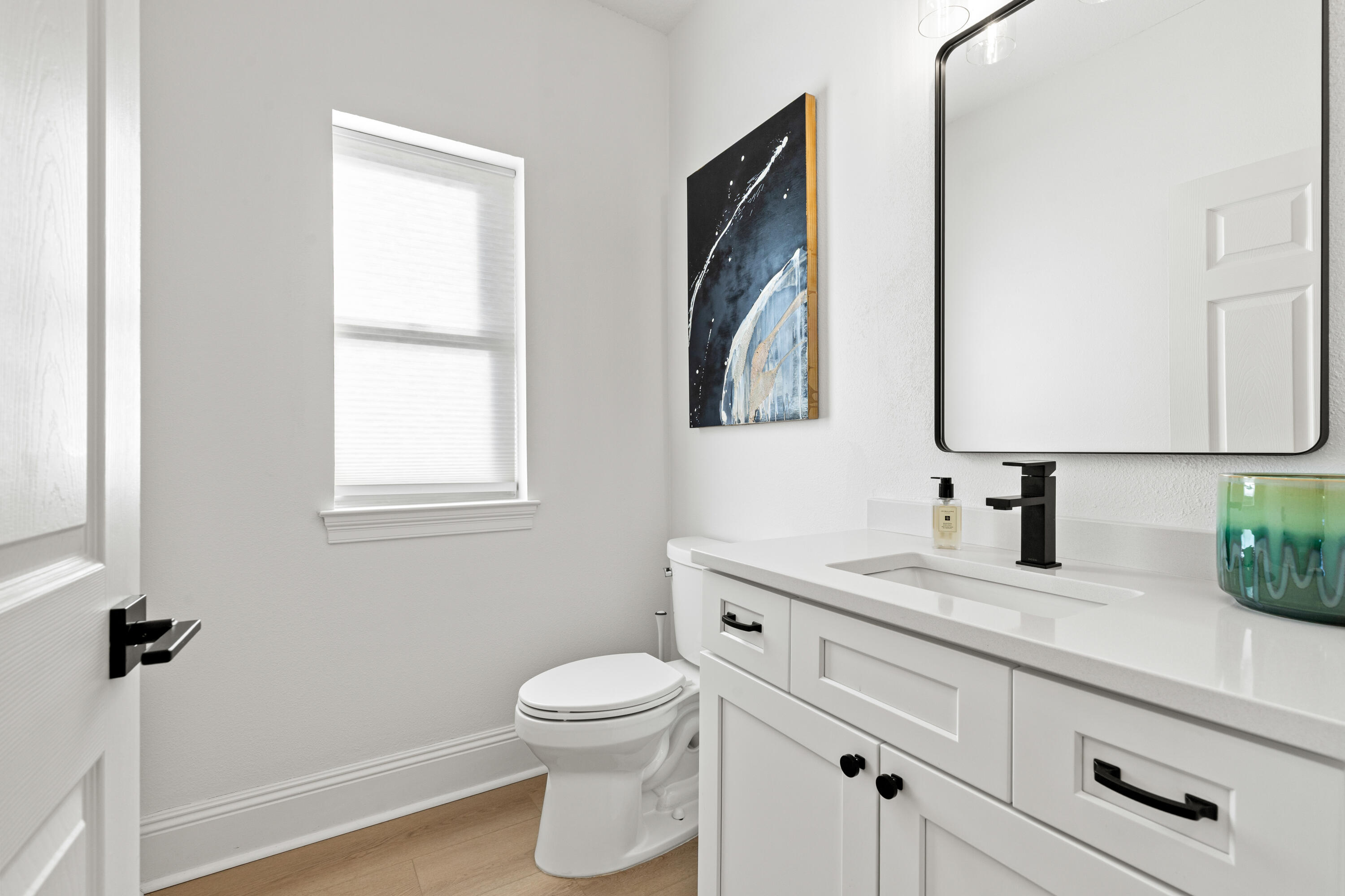 4591 Sailmaker Lane Destin, FL 32541 - Photo 27 of 41 a bathroom with a toilet sink and mirror