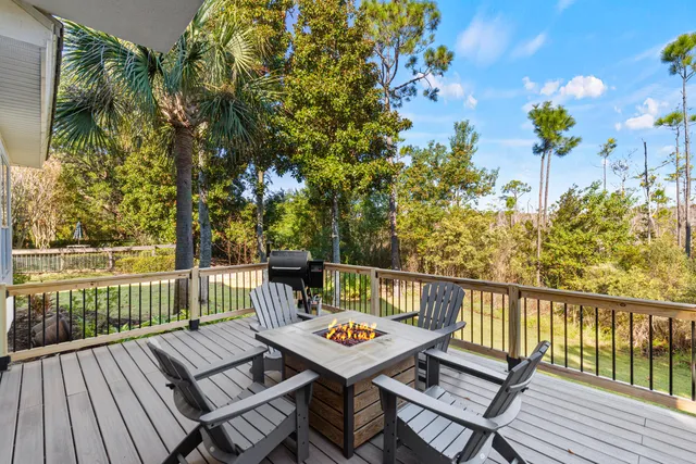 a view of a balcony with wooden floor and outdoor seating