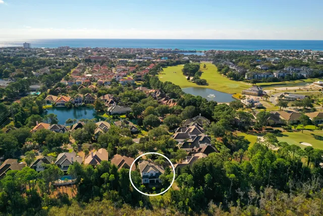 an aerial view of residential houses with outdoor space and swimming pool