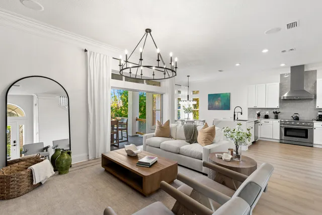 a living room with furniture fireplace and a chandelier
