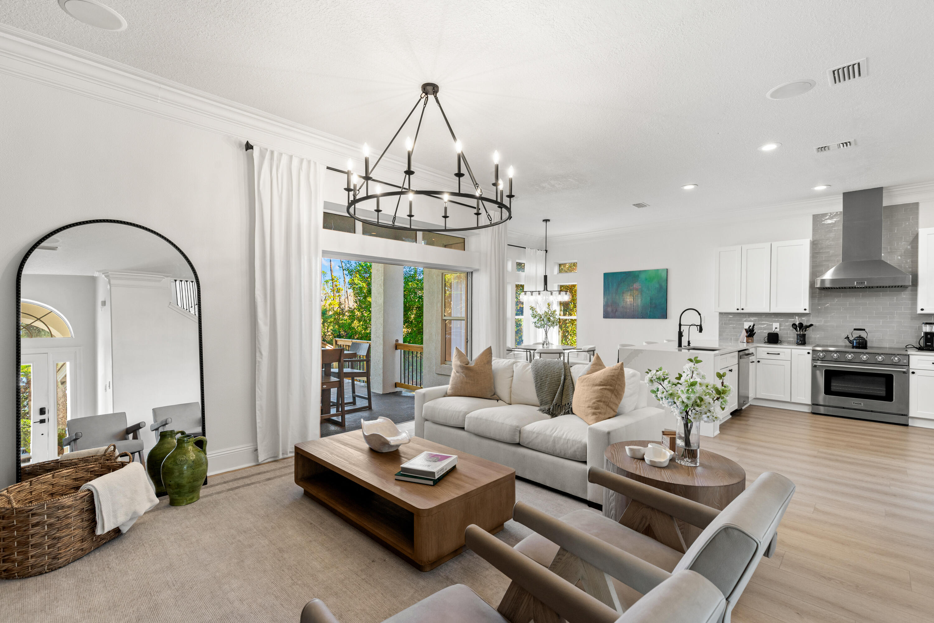 4591 Sailmaker Lane Destin, FL 32541 - Photo 4 of 41 a living room with furniture fireplace and a chandelier