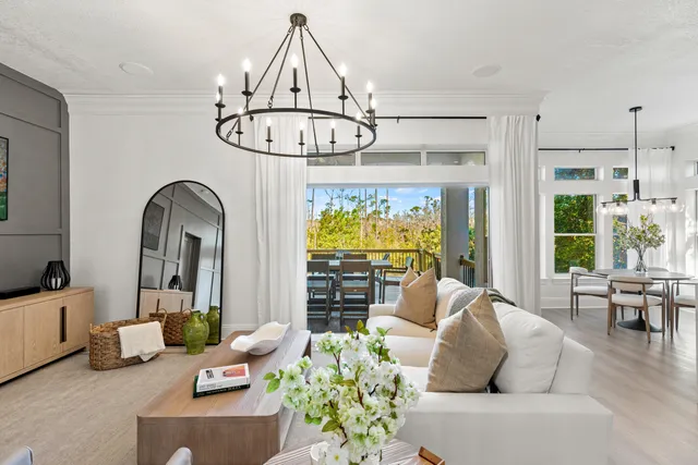 a living room with furniture a chandelier and a chandelier
