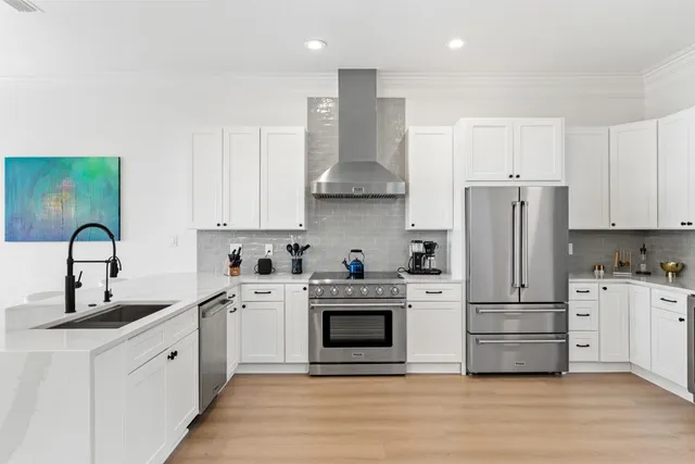a kitchen with cabinets stainless steel appliances and a sink