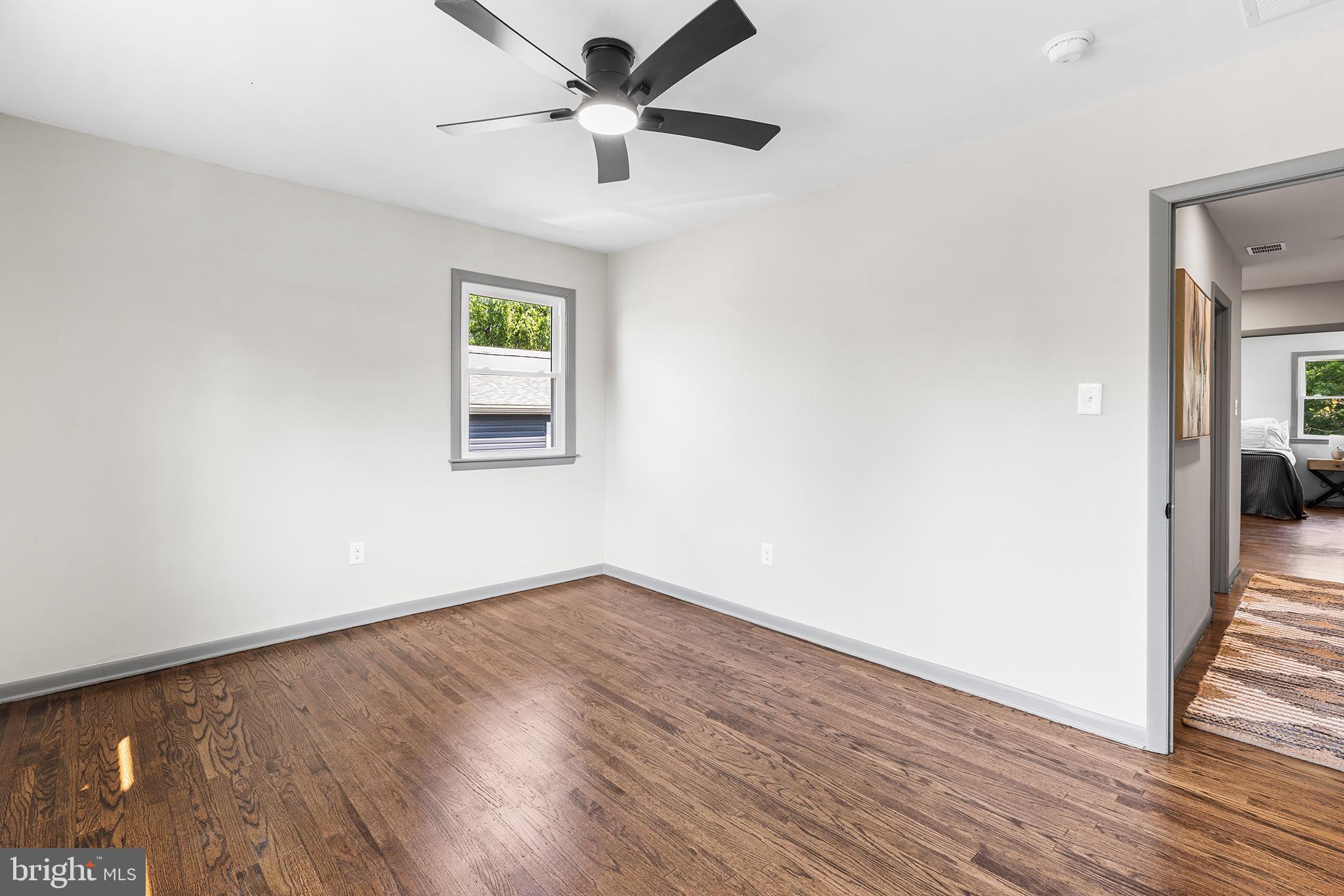 26 Virginia Circle Ridley Park, PA 19078 - Photo 27 of 49 an empty room with wooden floor chandelier fan and windows