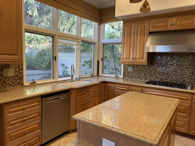 a kitchen with a sink and large window