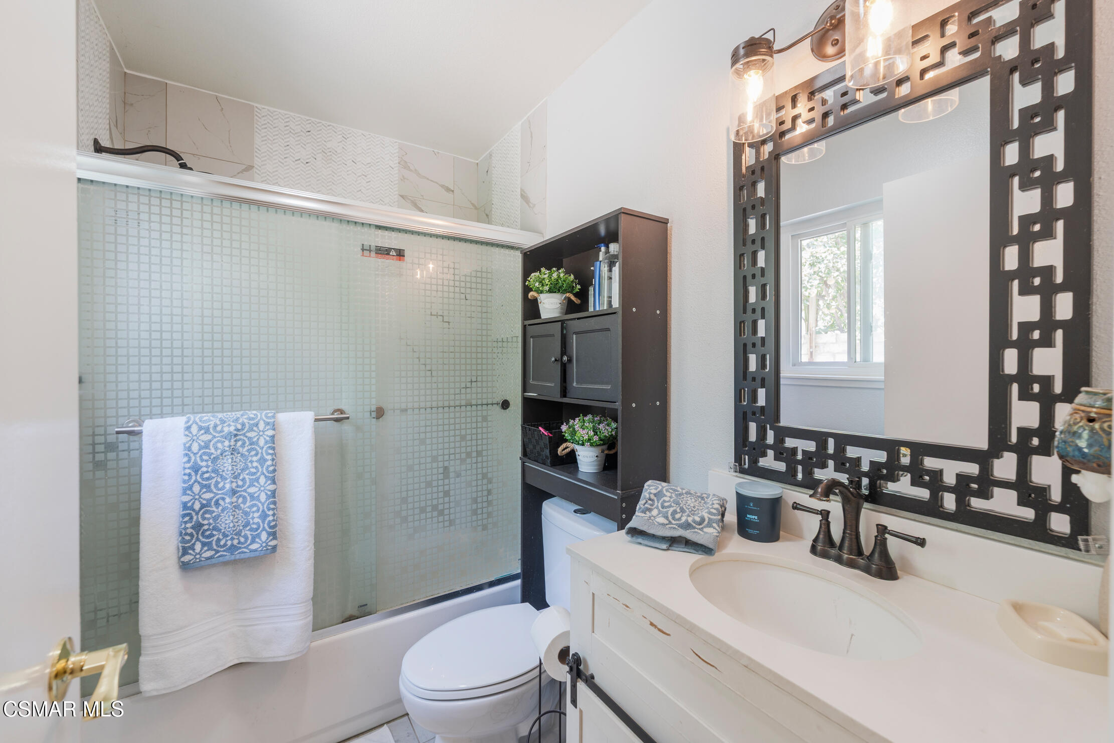 1917 Fitzgerald Road Simi Valley, CA 93065 - Photo 26 of 55 a bathroom with a sink a toilet and shower