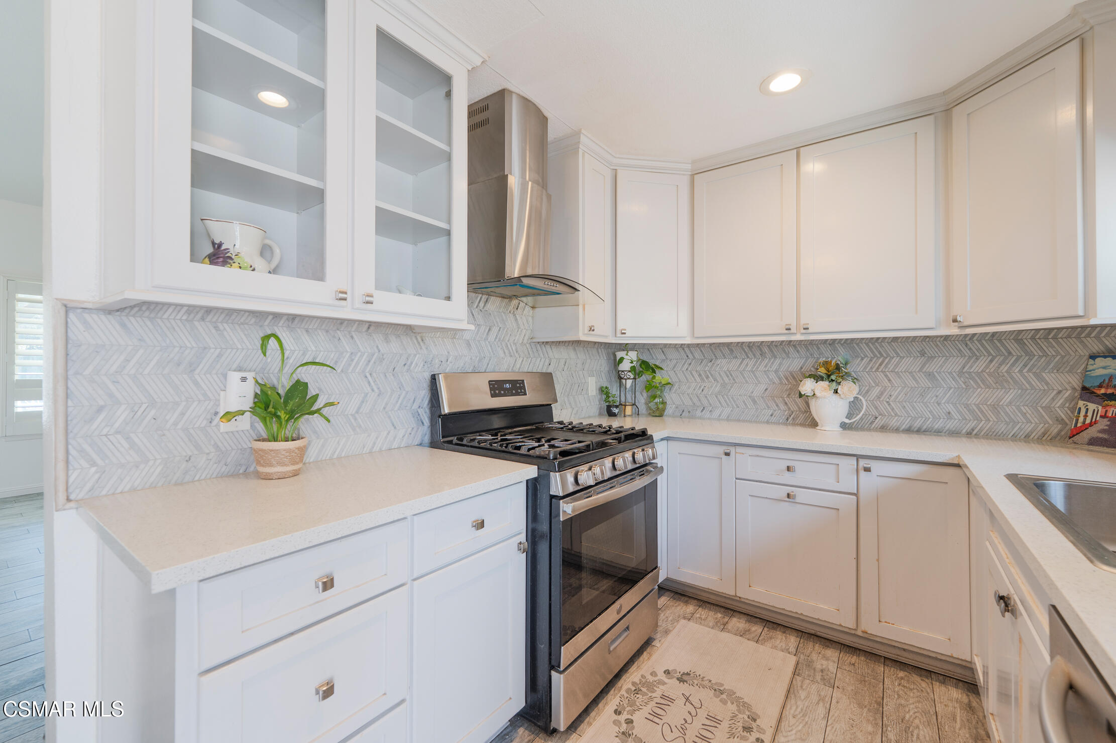 1917 Fitzgerald Road Simi Valley, CA 93065 - Photo 27 of 55 a kitchen with stainless steel appliances white cabinets and a stove top oven