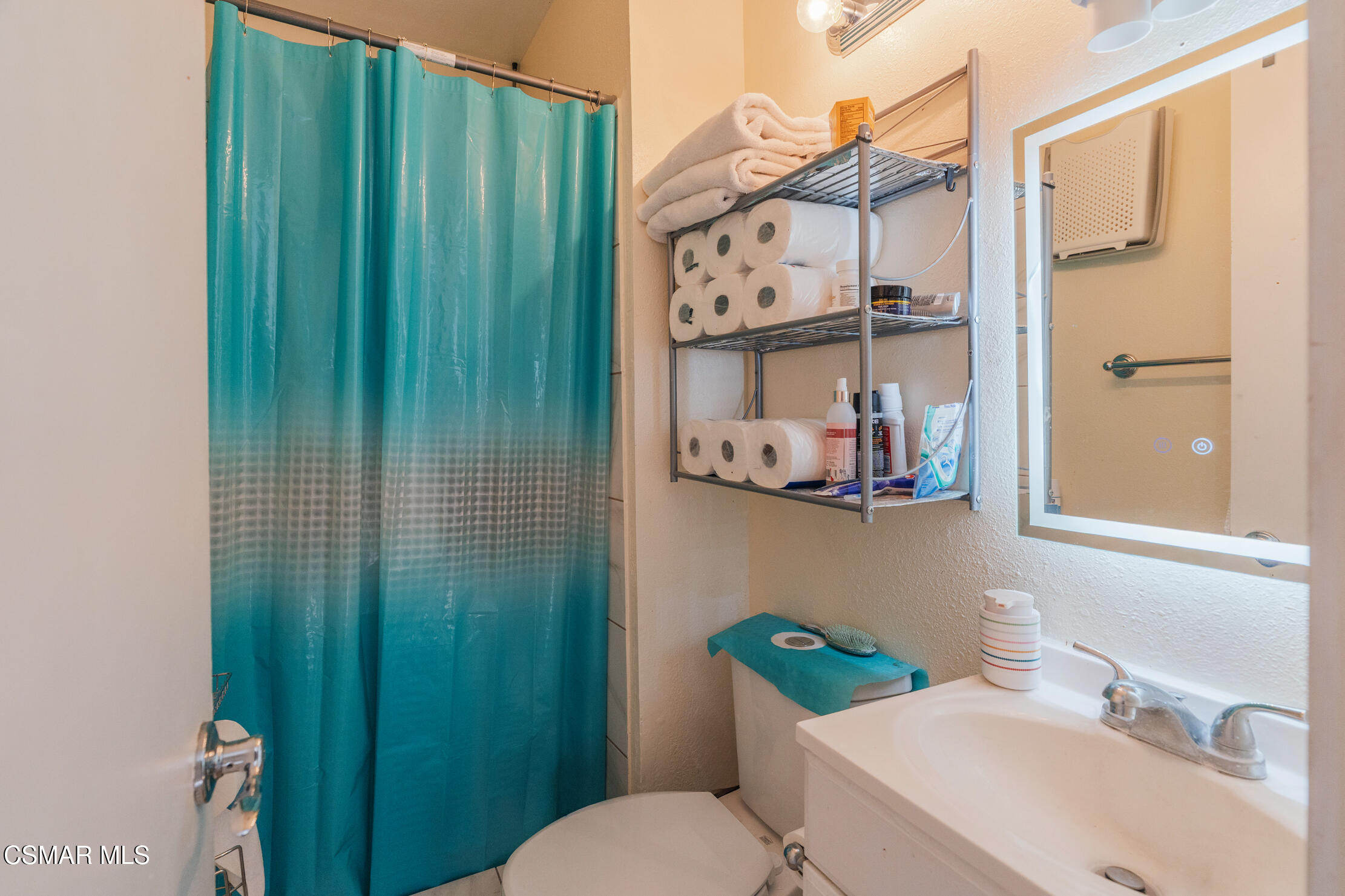 1917 Fitzgerald Road Simi Valley, CA 93065 - Photo 33 of 55 a bathroom with a sink a toilet and shower curtain