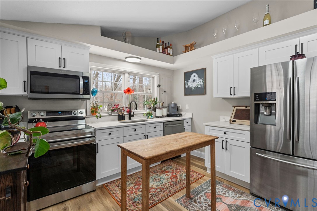 675 Goldmine Road Louisa, VA 23093 - Photo 17 of 29 a kitchen with stainless steel appliances a stove refrigerator sink and microwave