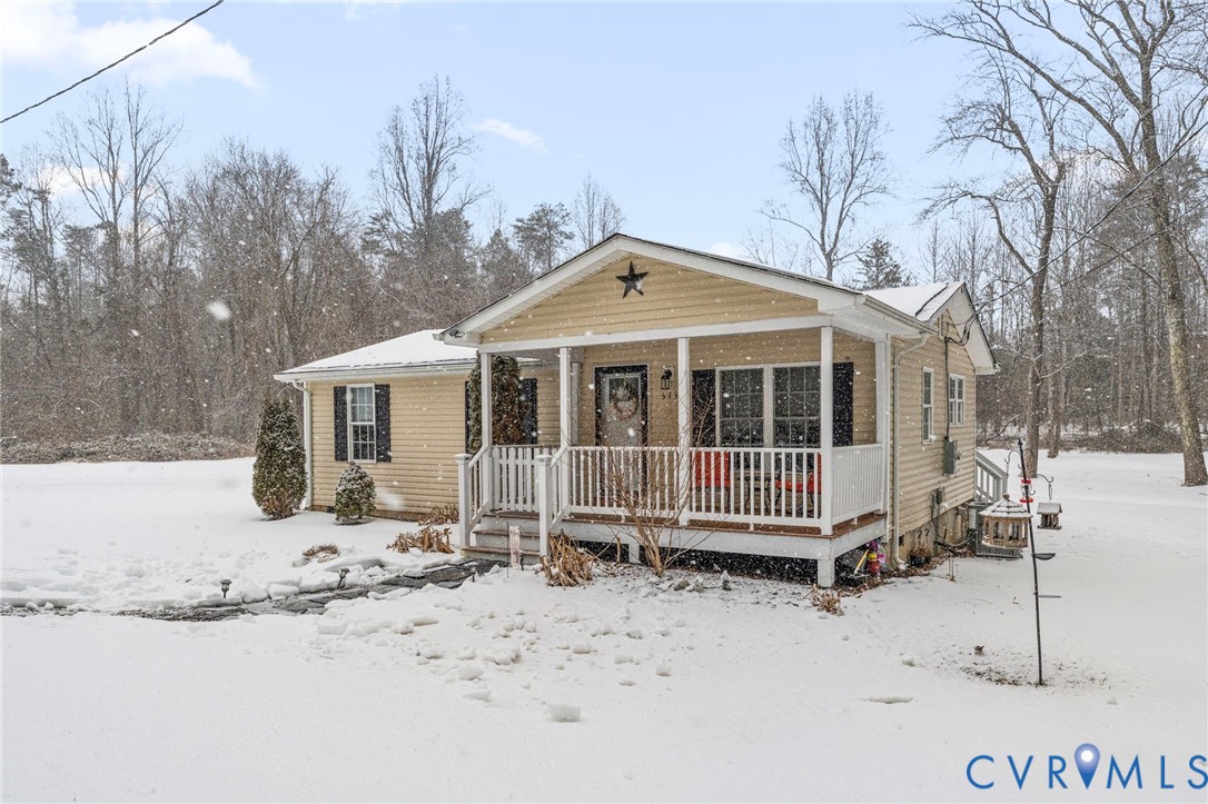 675 Goldmine Road Louisa, VA 23093 - Photo 22 of 29 a front view of a house with a yard covered in snow