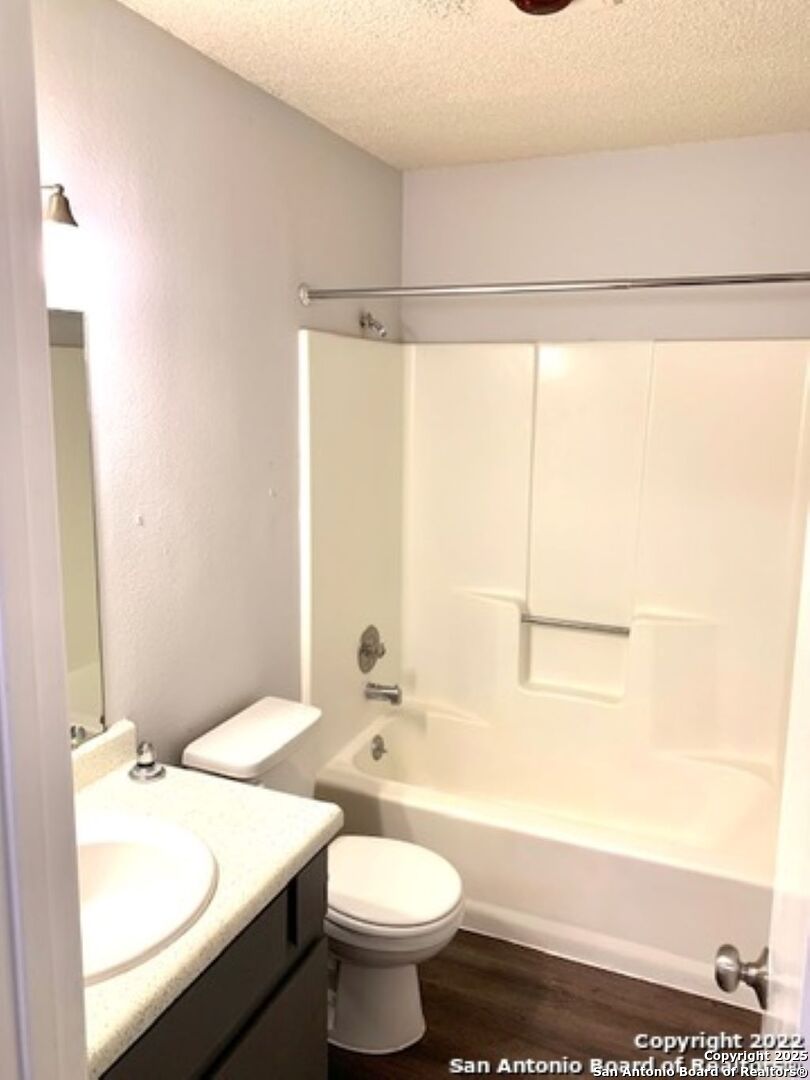 5230 Meadow Rise Street San Antonio, TX 78250 - Photo 15 of 30 a bathroom with a sink a toilet and shower