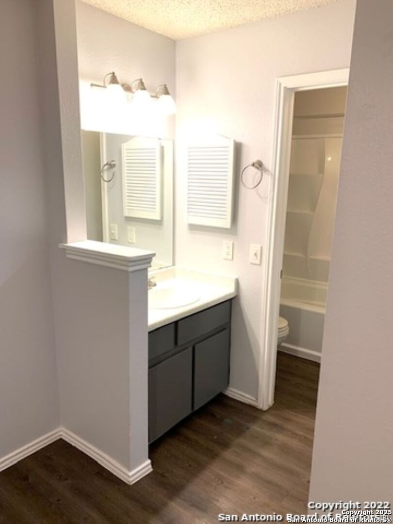 5230 Meadow Rise Street San Antonio, TX 78250 - Photo 16 of 30 a bathroom with a sink a mirror and a shower