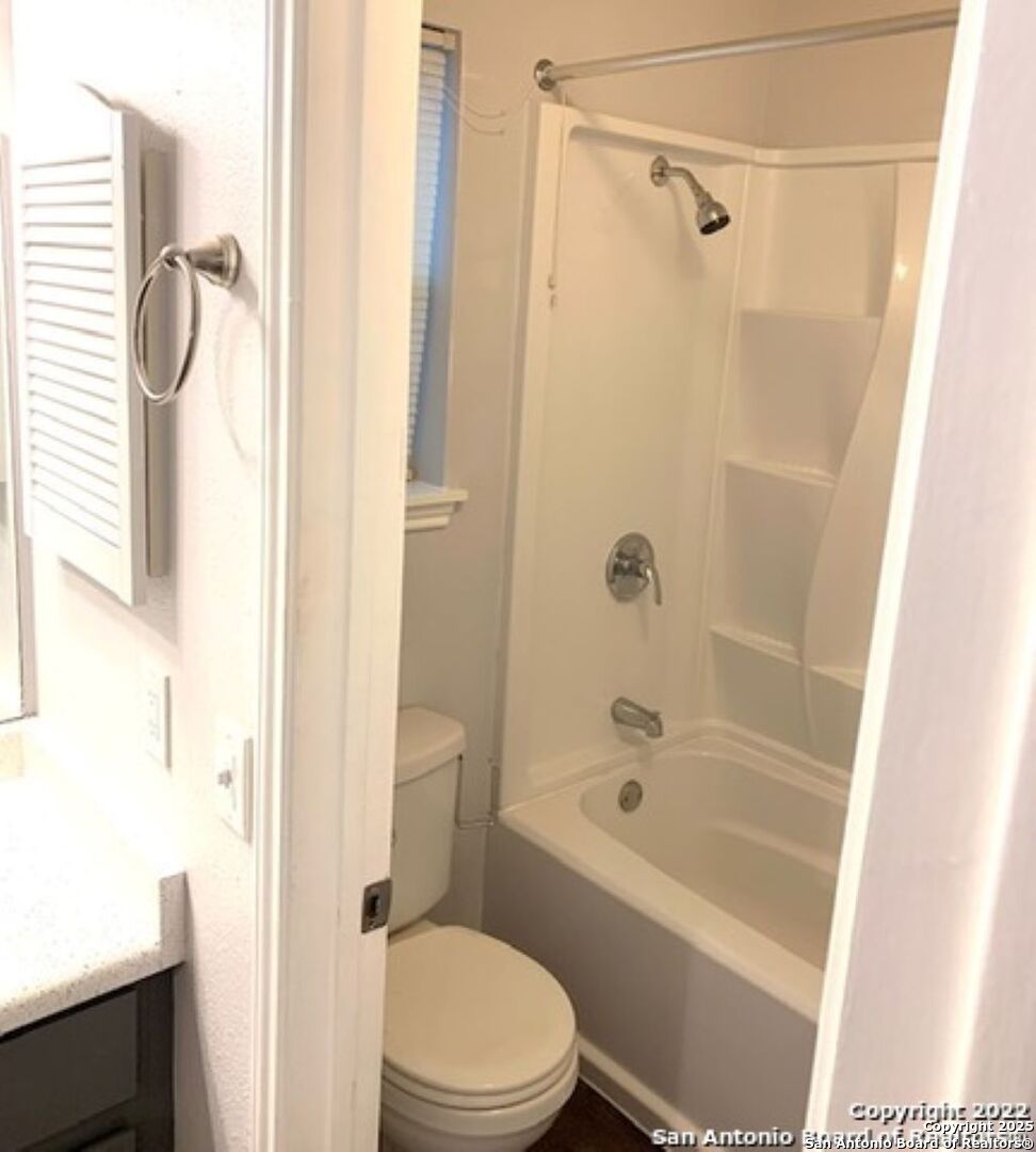 5230 Meadow Rise Street San Antonio, TX 78250 - Photo 17 of 30 a bathroom with a toilet and shower