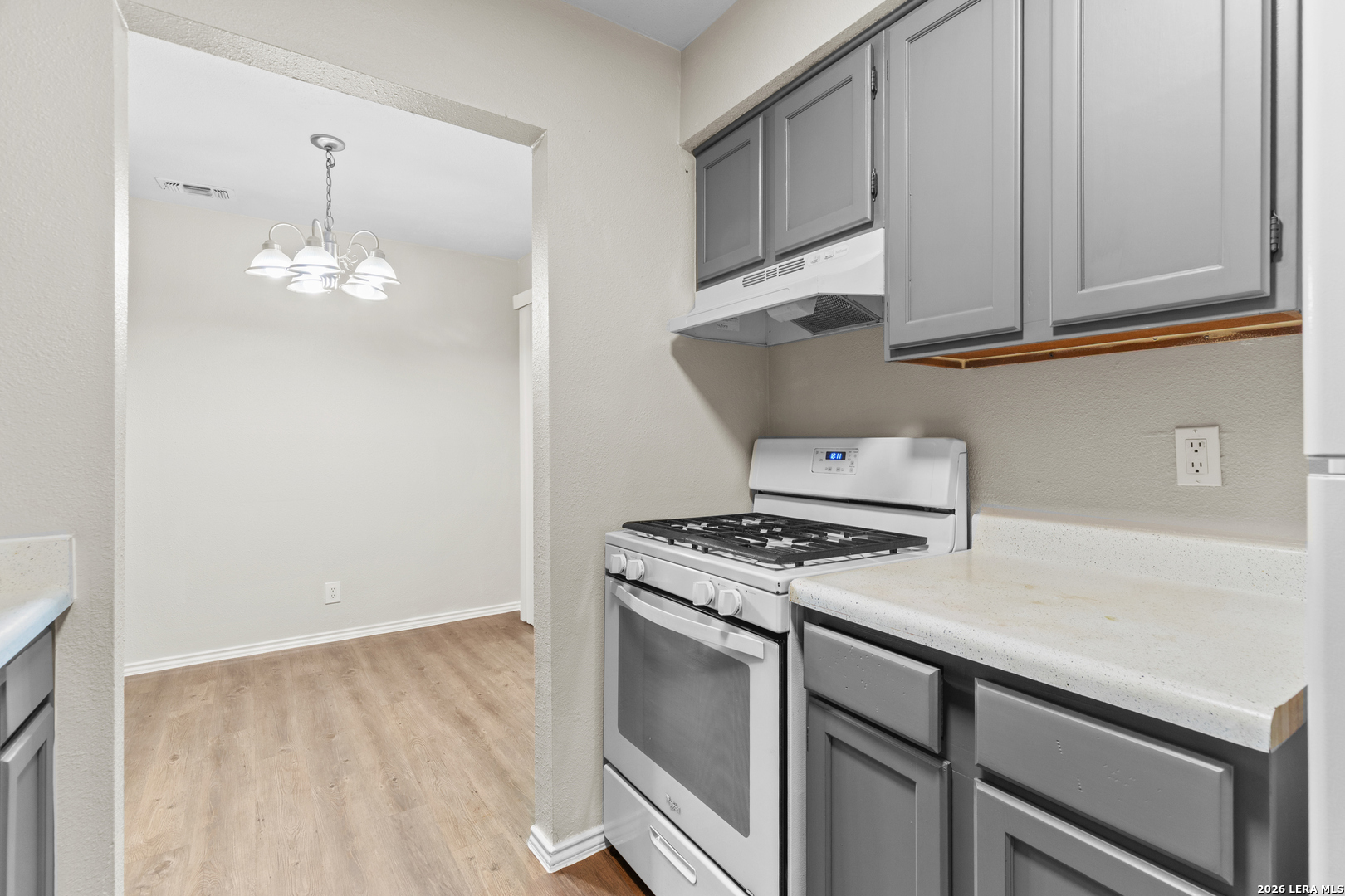 5230 Meadow Rise Street San Antonio, TX 78250 - Photo 20 of 30 a kitchen with cabinets appliances and a wooden floor
