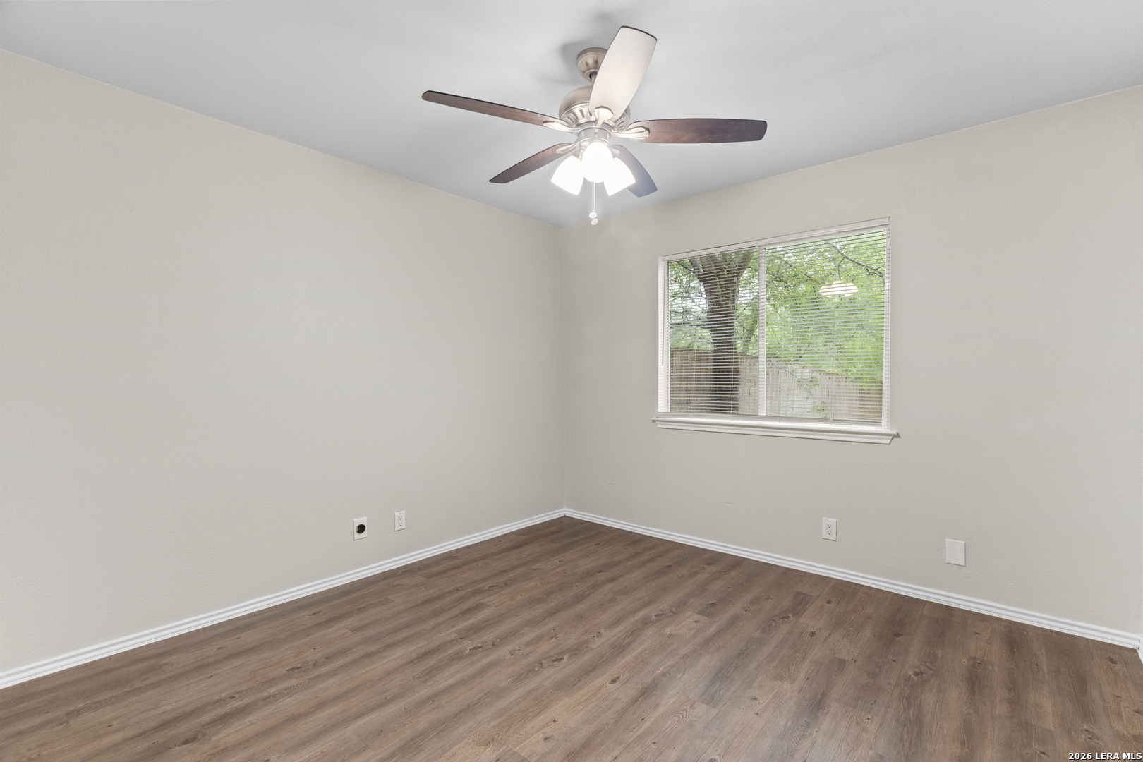 5230 Meadow Rise Street San Antonio, TX 78250 - Photo 22 of 30 wooden floor in an empty room with a window