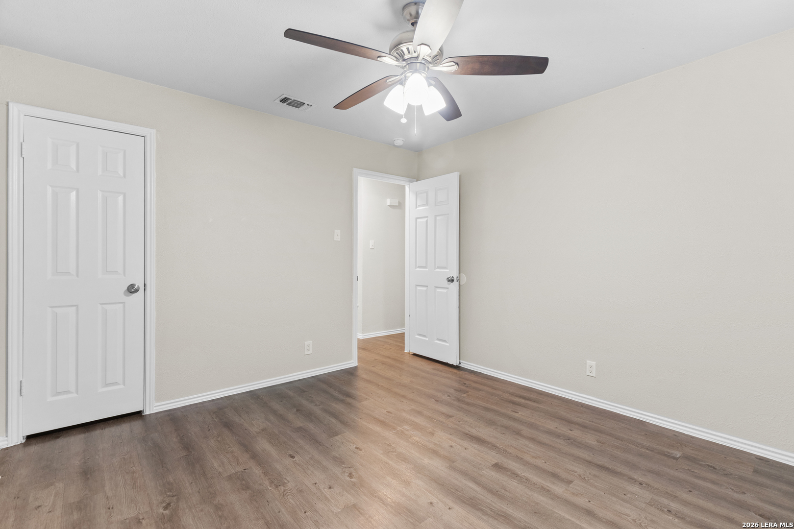 5230 Meadow Rise Street San Antonio, TX 78250 - Photo 25 of 30 a view of an empty room with wooden floor