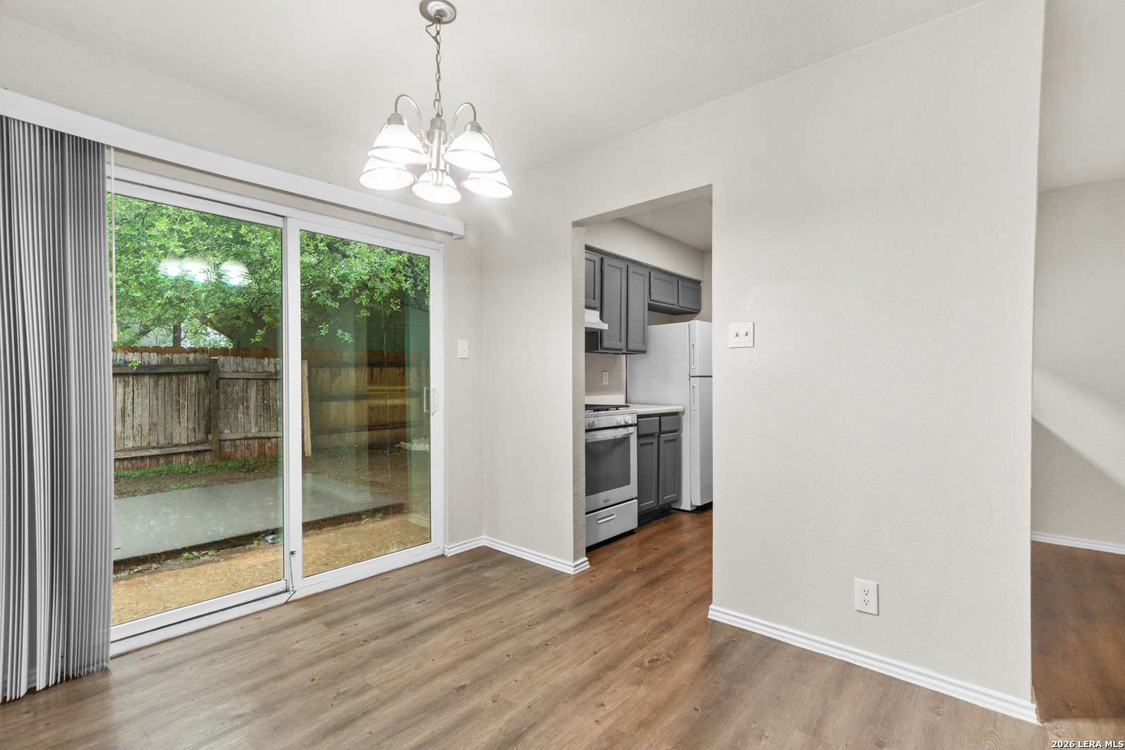 5230 Meadow Rise Street San Antonio, TX 78250 - Photo 26 of 30 a view of a room with wooden floor chandeliers and kitchen