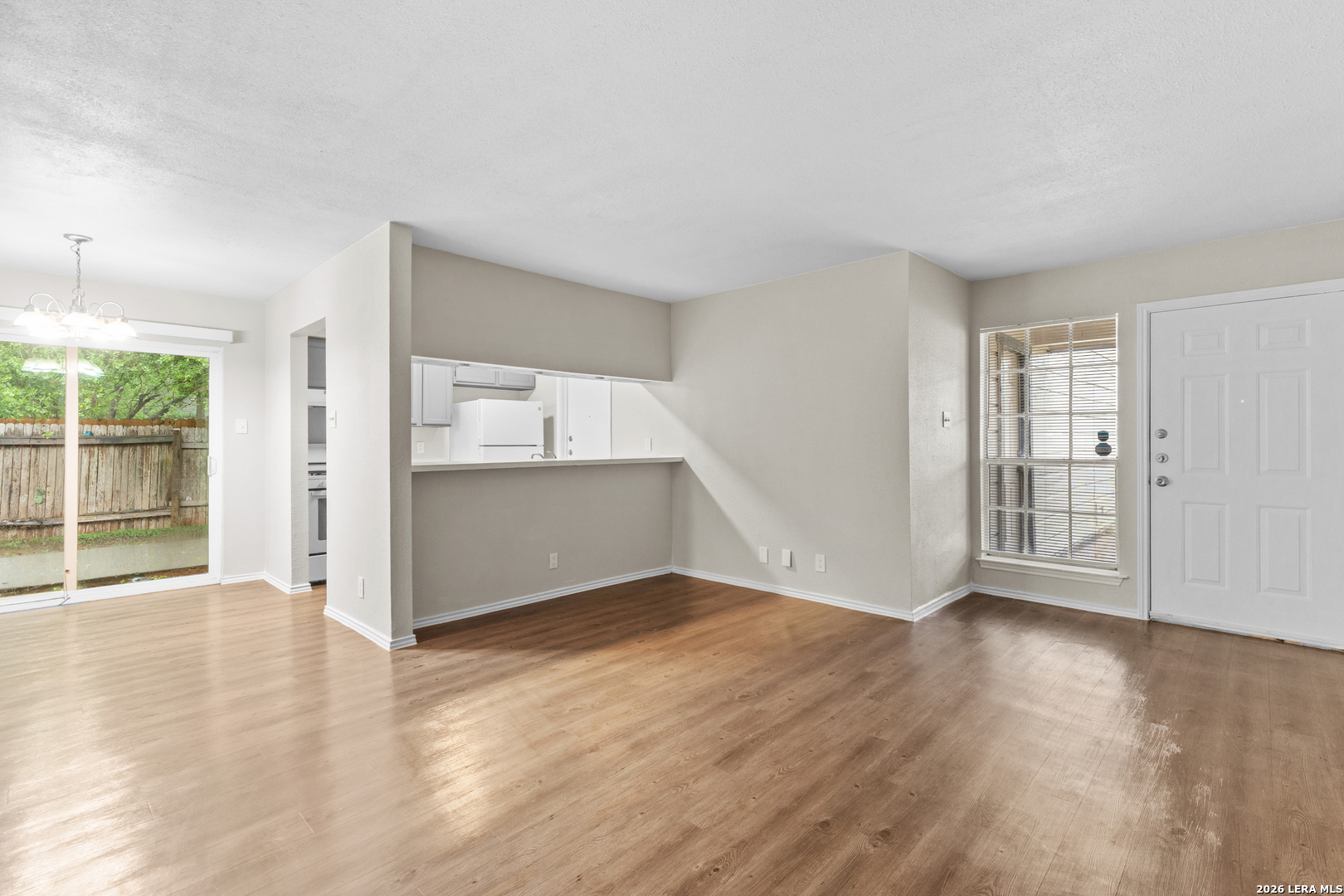 5230 Meadow Rise Street San Antonio, TX 78250 - Photo 29 of 30 an empty room with wooden floor and windows