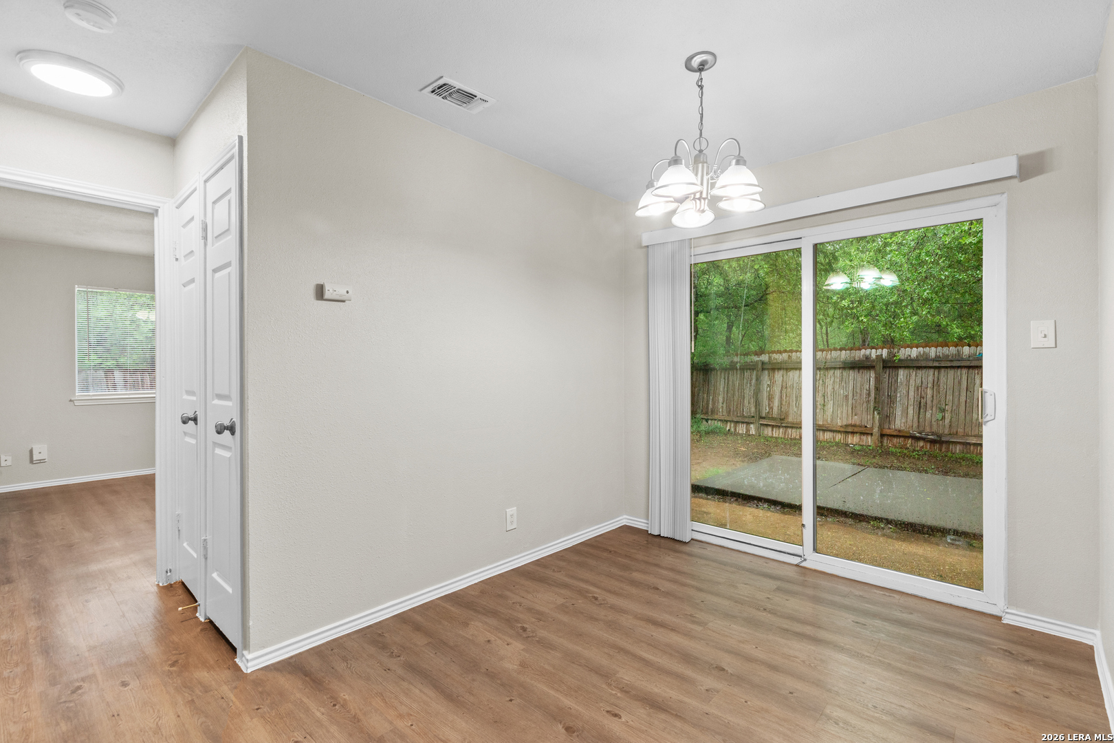 5230 Meadow Rise Street San Antonio, TX 78250 - Photo 30 of 30 wooden floor in an empty room with a window