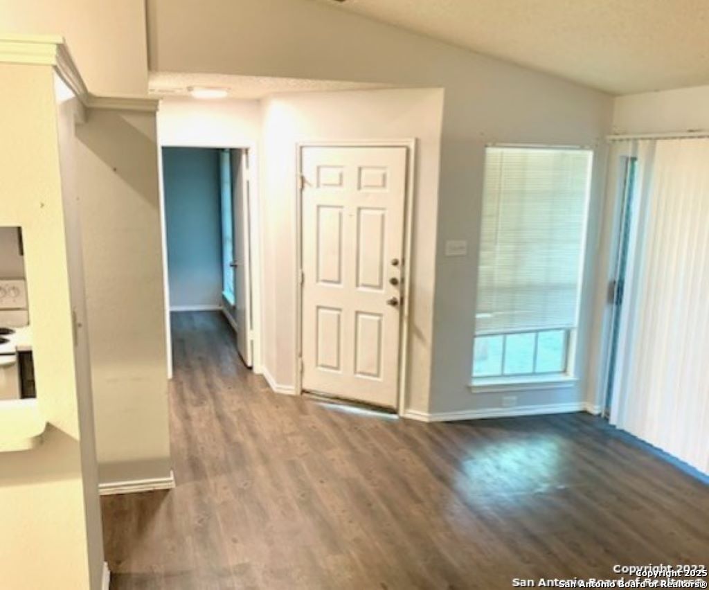 5230 Meadow Rise Street San Antonio, TX 78250 - Photo 8 of 30 a view of a hallway with wooden floor and a living room