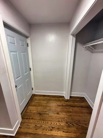 a view of room with hardwood floor and staircase