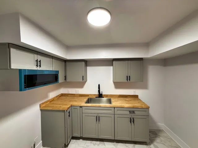 a kitchen with sink and cabinets