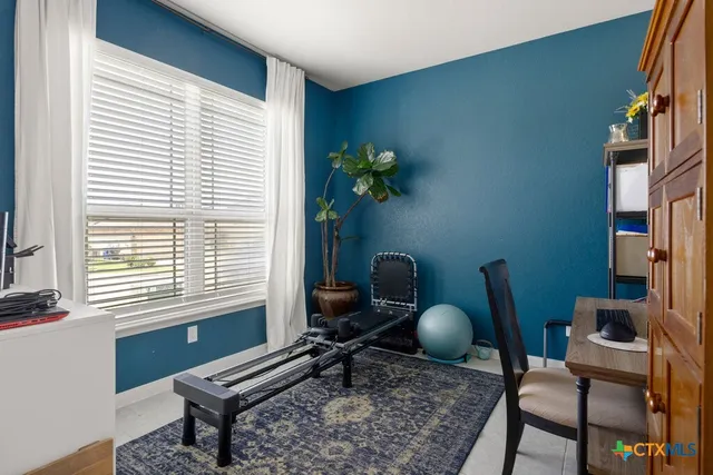 a work room with furniture and a window