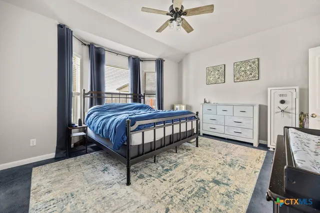 a bedroom with a bed dresser and a window