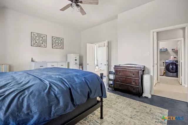 a bedroom with a bed and a chandelier