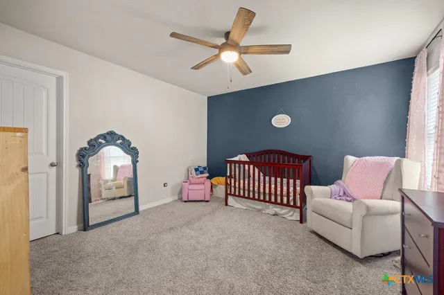 a bedroom with furniture and a window