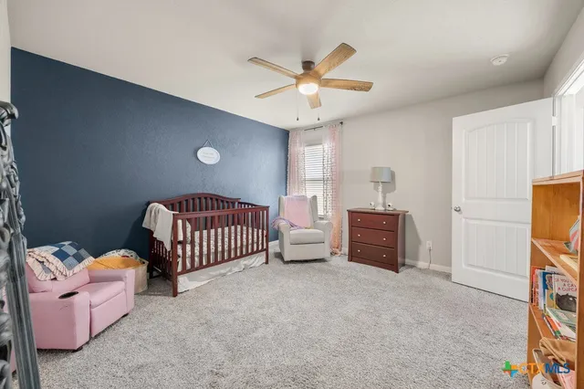 a bedroom with furniture and a ceiling fan