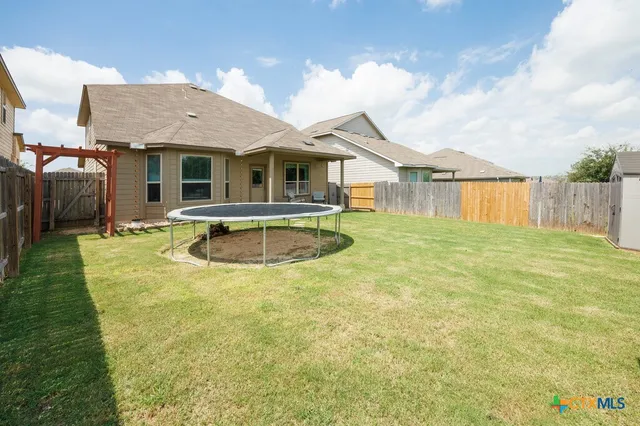 a front view of a house with swimming pool having outdoor seating