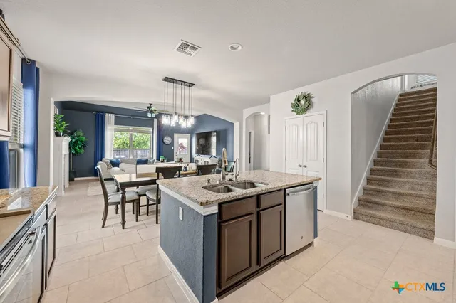 a kitchen with a sink and cabinets