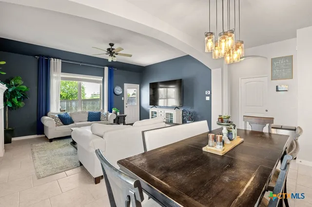 a living room with fireplace furniture and a chandelier