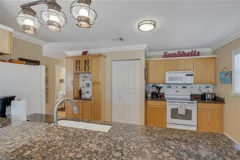 a kitchen with a refrigerator and a stove top oven