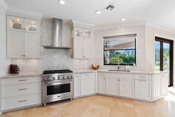 a kitchen with white cabinets and white appliances