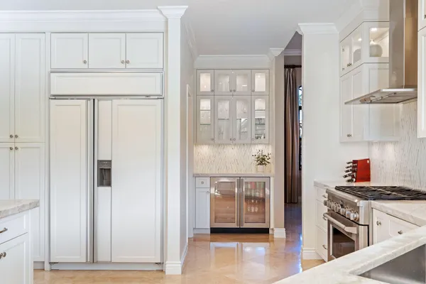 a kitchen with stainless steel appliances granite countertop a refrigerator and a stove top oven