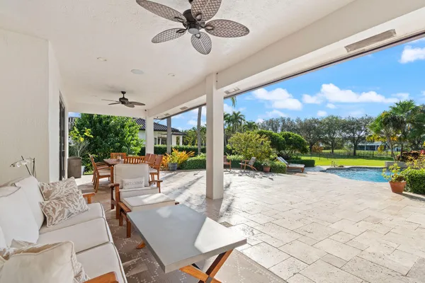a view of a swimming pool and outdoor seating