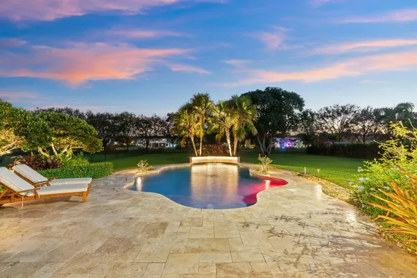 a view of swimming pool with a lounge chairs
