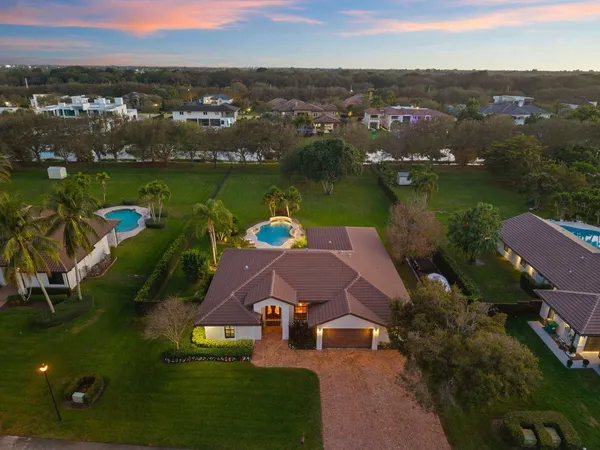 an aerial view of a house with outdoor space lake view and boat