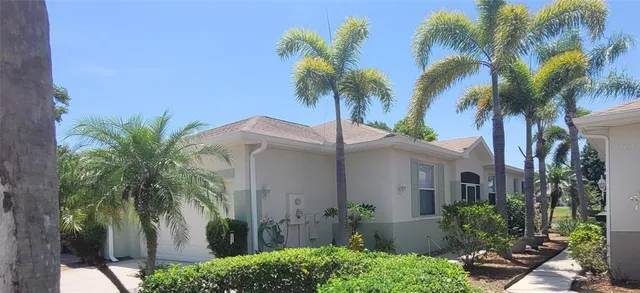 a view of a house with a palm trees